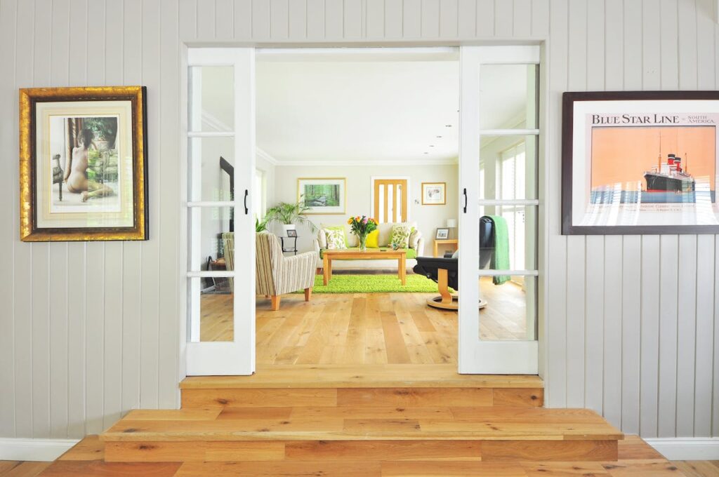 doorway into white living room with green rug