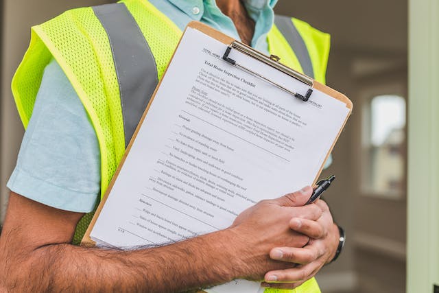 A person holding a home inspection checklist