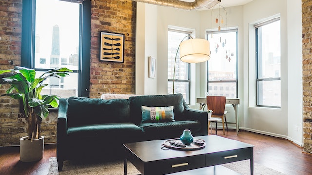 living room couch with brick walls