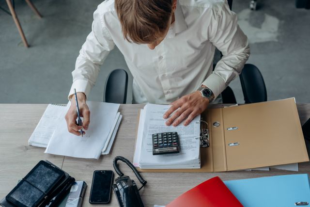 person in an office reviewing financial papers