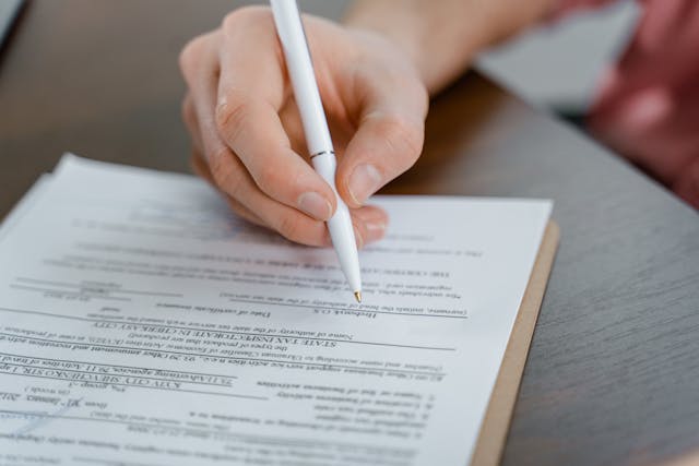 person-signing-business-papers